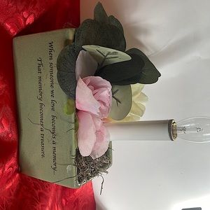 Floral ceramic vase with candle.